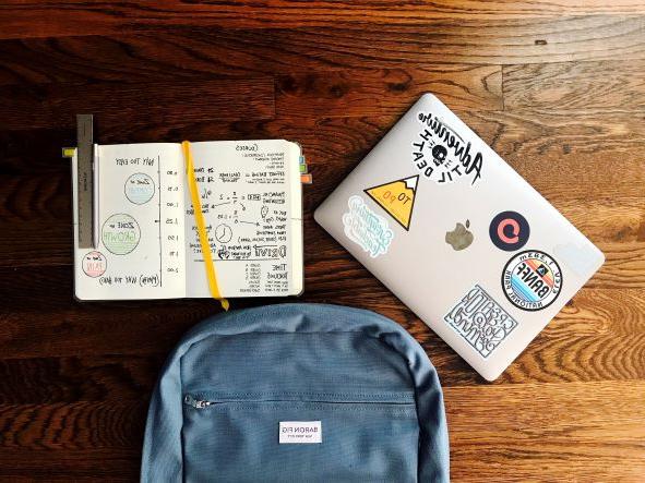 image of backpack and paper notepad